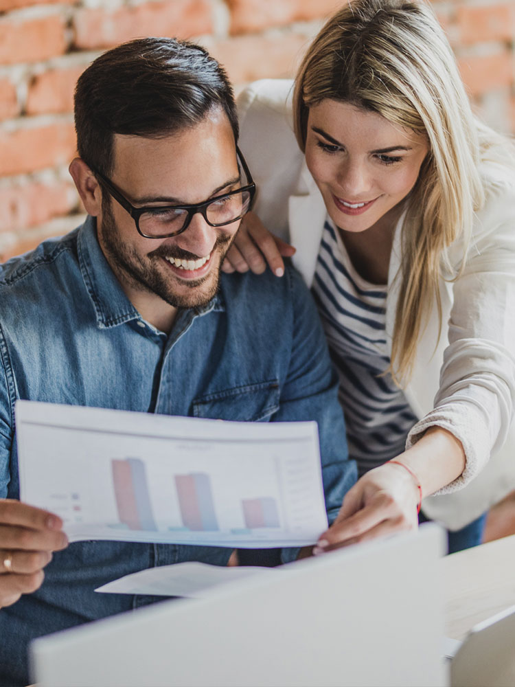 a group of people looking at a laptop